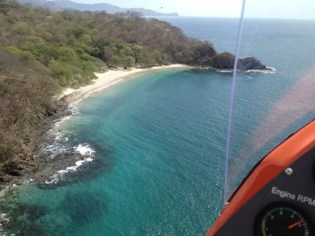 A turquoise coastal bay seen from a gyroplane