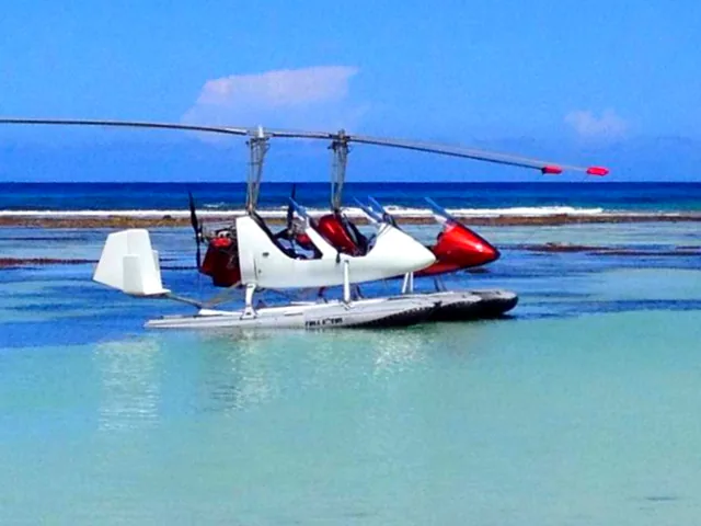 A gyroplane on floats in tropical water