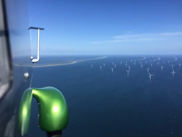 Coastal waters and offshore wind turbines seen from a gyroplane